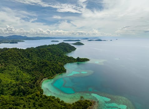Aerial drone of coast with rainforest and tropical islands in the bay. Borneo. Sabah, Malaysia.