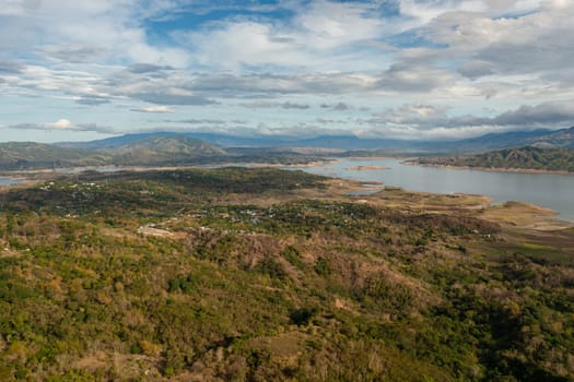 Lake in a valley among mountains with tropical vegetation. Philippines.