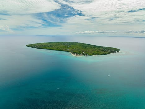 Tropical island with a beach in the open ocean. Virgin Island, Philippines.