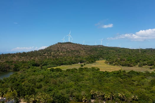 Aerial drone of Wind turbines producing clean sustainable energy, clean energy future. Wind power plant. Philippines.