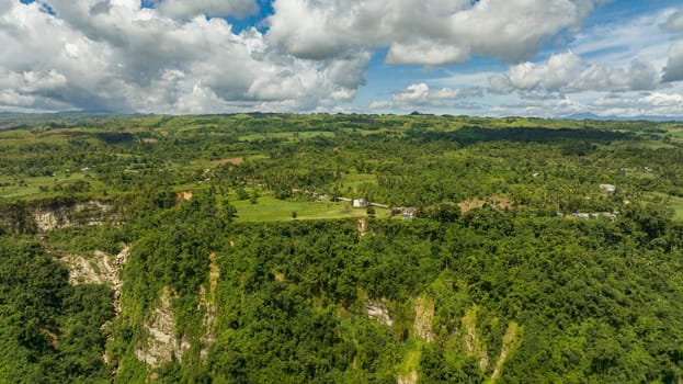 Hills and mountains with green tropical vegetation and trees in the tropics. Clifftop View. Negros, Philippines