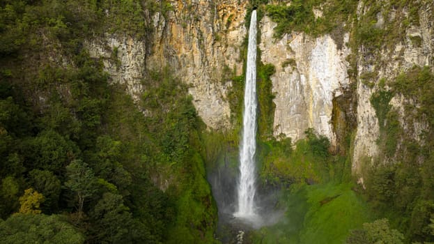 Waterfall in a tropical forest. Sipiso Piso falls. Sumatra, Indonesia.