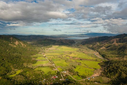 Mountain slopes with rainforest and a mountain valley with farmland. Philippines.