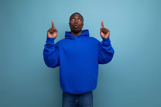 a handsome short-haired brunette African in a basic hoodie demonstrates the mind and resourcefulness of an idea.