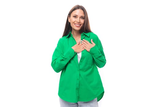 attractive young brown-haired female model with brown eyes in green shirt isolated on white background.