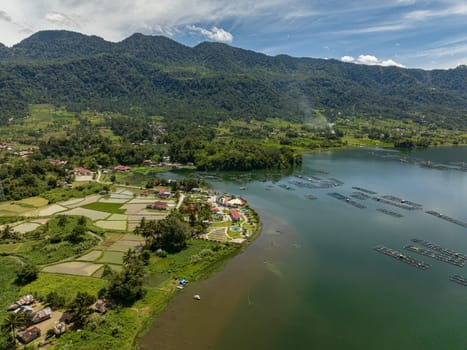 Aerial view of farmland and rice fields on the Maninjau lake shore in the mountains. Sumatra, Indonesia.