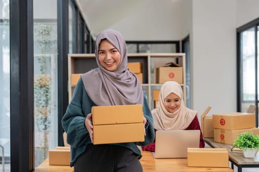 Beauty muslim woman in hijab working sell products online in the office.