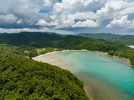 A bay with a beautiful beach among tropical vegetation. Loro Kecil beach. Borneo, Malaysia.