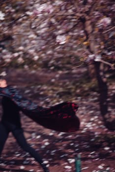 Beautiful dramatic young woman wearing kimono with cherry blossoms, sakura view. High quality photo