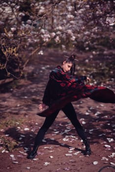 Beautiful dramatic young woman wearing kimono with cherry blossoms, sakura view. High quality photo
