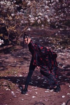 Beautiful dramatic young woman wearing kimono with cherry blossoms, sakura view. High quality photo