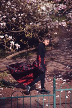 Beautiful dramatic young woman wearing kimono with cherry blossoms, sakura view. High quality photo