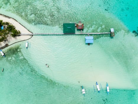 Tropical island on an atoll with a beautiful beach. Onok Island, Balabac, Philippines.