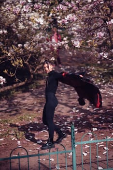Beautiful dramatic young woman wearing kimono with cherry blossoms, sakura view. High quality photo