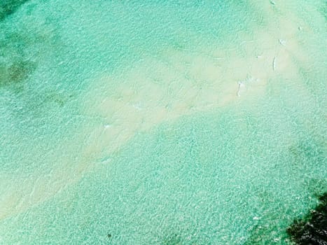 Aerial view of turquoise lagoon surface on atoll and coral reef, copy space for text. Balabac, Palawan. Philippines.