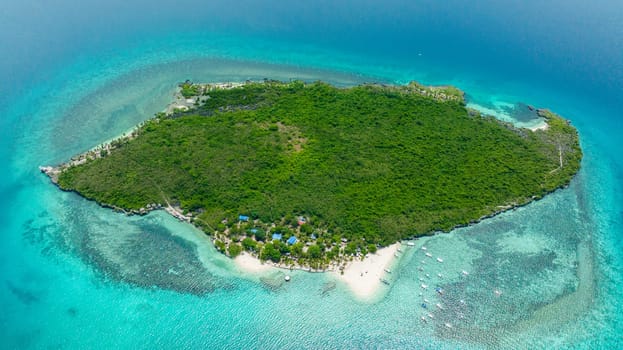 Top view of tropical island with a beach in the open ocean. Virgin Island, Philippines.