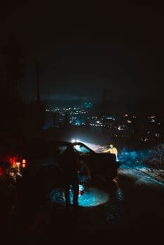 Man preparing bbq grill to cook on fire. Outside dark shot. Freeze moment of fire. High quality photo