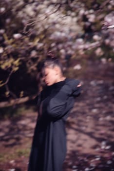 Beautiful dramatic young woman wearing kimono with cherry blossoms, sakura view. High quality photo