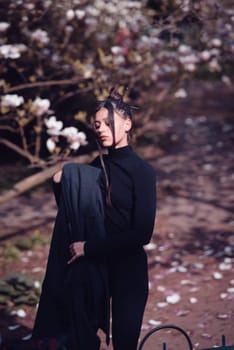 Beautiful dramatic young woman wearing kimono with cherry blossoms, sakura view. High quality photo