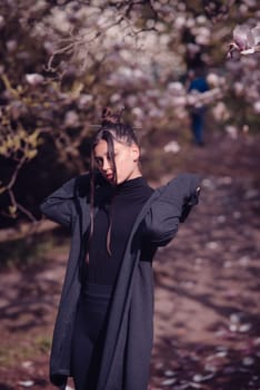 Beautiful dramatic young woman wearing kimono with cherry blossoms, sakura view. High quality photo