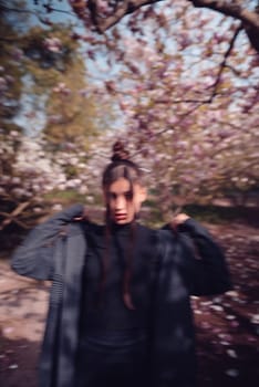 Beautiful dramatic young woman wearing kimono with cherry blossoms, sakura view. High quality photo