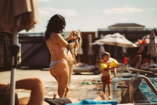 back view of pregnant woman in bikini on the beach. High quality photo