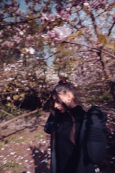 Beautiful dramatic young woman wearing kimono with cherry blossoms, sakura view. High quality photo