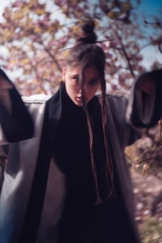 Beautiful dramatic young woman wearing kimono with cherry blossoms, sakura view. High quality photo