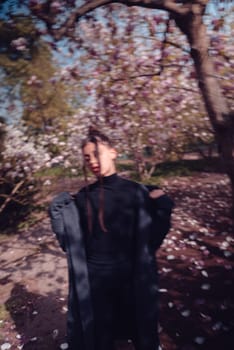Beautiful dramatic young woman wearing kimono with cherry blossoms, sakura view. High quality photo
