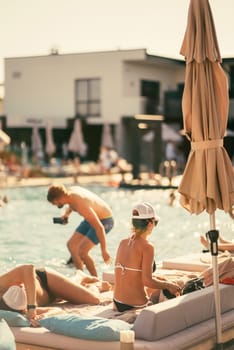 back view of people sunbathing on the beach. High quality photo