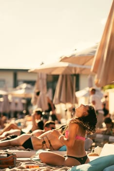 back view of beautiful girl in bikini on the beach. High quality photo