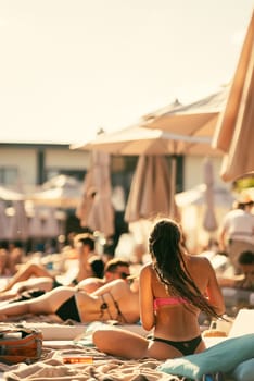 back view of beautiful girl in bikini on the beach. High quality photo