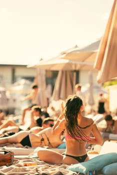 back view of beautiful girl in bikini on the beach. High quality photo