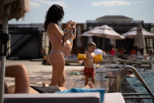 back view of pregnant woman in bikini on the beach. High quality photo