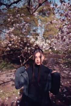 Beautiful dramatic young woman wearing kimono with cherry blossoms, sakura view. High quality photo
