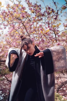 Beautiful dramatic young woman wearing kimono with cherry blossoms, sakura view. High quality photo