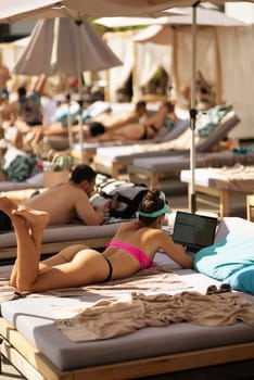 beautiful girl in bikini laying and sunbathing on the beach. High quality photo