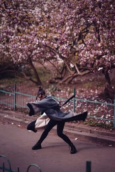 Beautiful dramatic young woman wearing kimono with cherry blossoms, sakura view. High quality photo