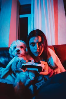 Close up portrait of A gamer or a streamer girl at home in a dark room with a game controller playing with her dog and sits in front of a monitor or TV. High quality photo