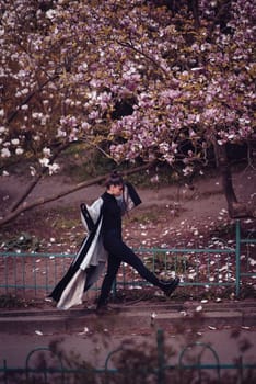 Beautiful dramatic young woman wearing kimono with cherry blossoms, sakura view. High quality photo