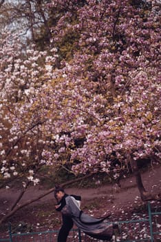 Beautiful dramatic young woman wearing kimono with cherry blossoms, sakura view. High quality photo