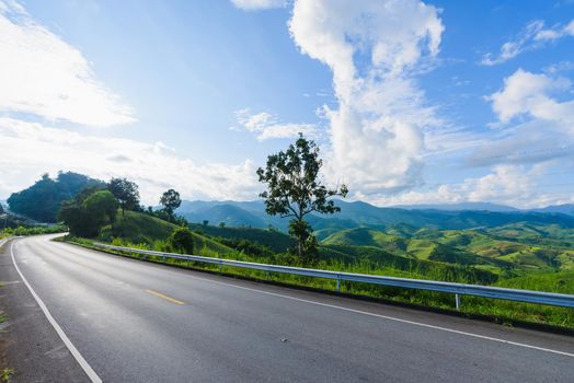 Winding road mountain blue sky