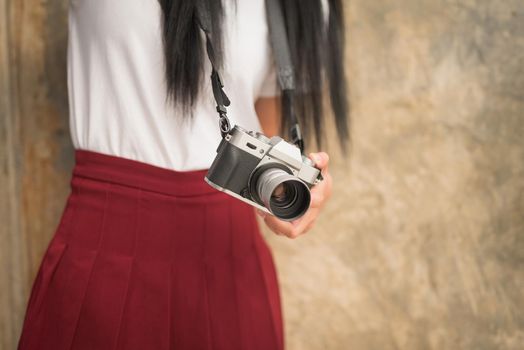Girl with vintage camera in the hands