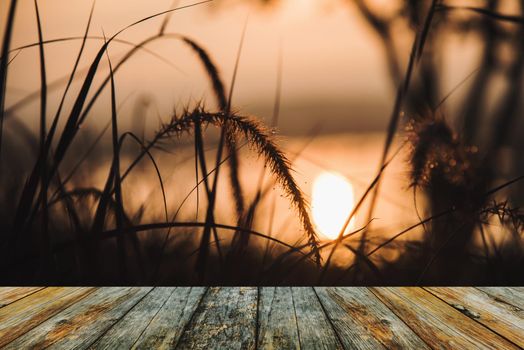 Wood floor view of the sunrise from grassy