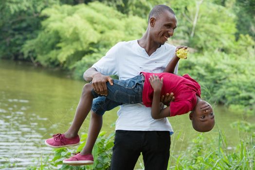 Happy father and little son playing and having fun outdoors .Concept of family, childhood and paternity united and happy
