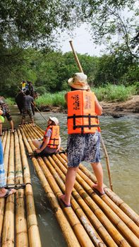 CHIANG MAI, THAILAND - JULY 18: Tourists are rafting trips in the creek with bamboo float rafting on July 18,2016 in Chiangmai Thailand -Northern Thailand