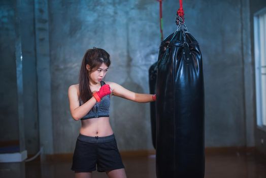 sexy asia girl punching boxing bag