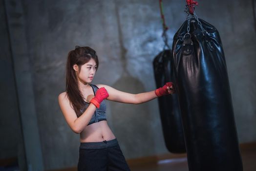 sexy asia girl punching boxing bag