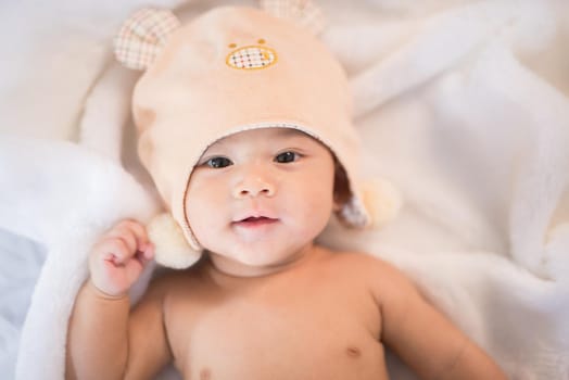 portrait asia baby on white bed