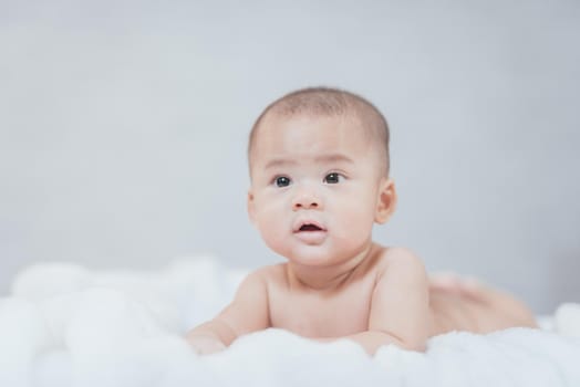 portrait asia baby on white bed